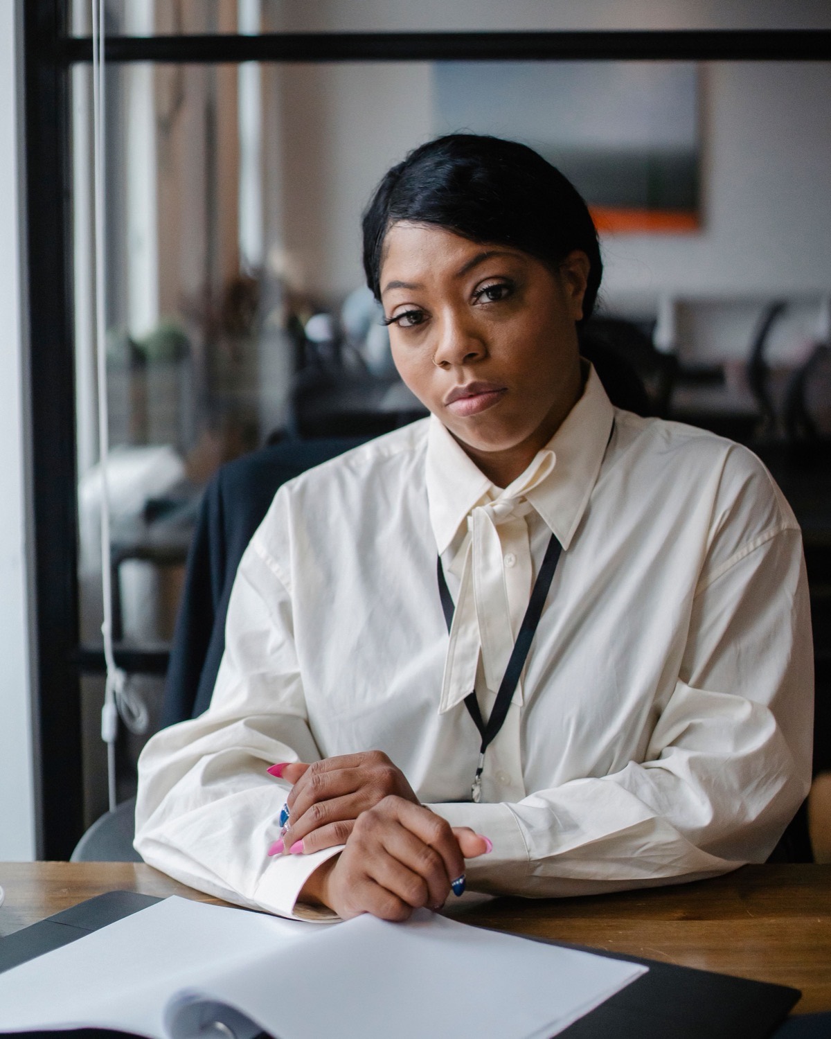 A payroll lead reviewing salary figures at her desk